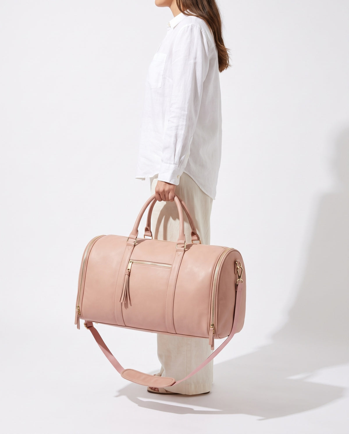 The OneBag in Blush and Champagne — carried for scale.