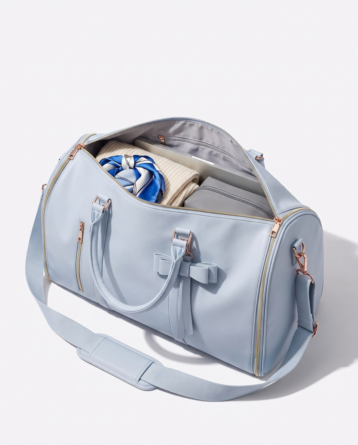 The OneBag in Como Sky — packed interior; contents shown for styling.