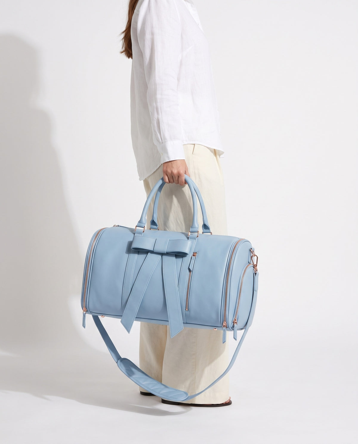 The OneBag in Como Sky — carried for scale.