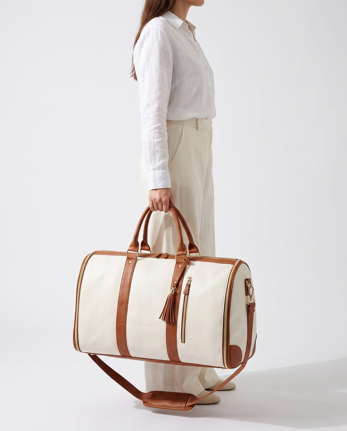 The OneBag in Ivory & Cognac — carried for scale.